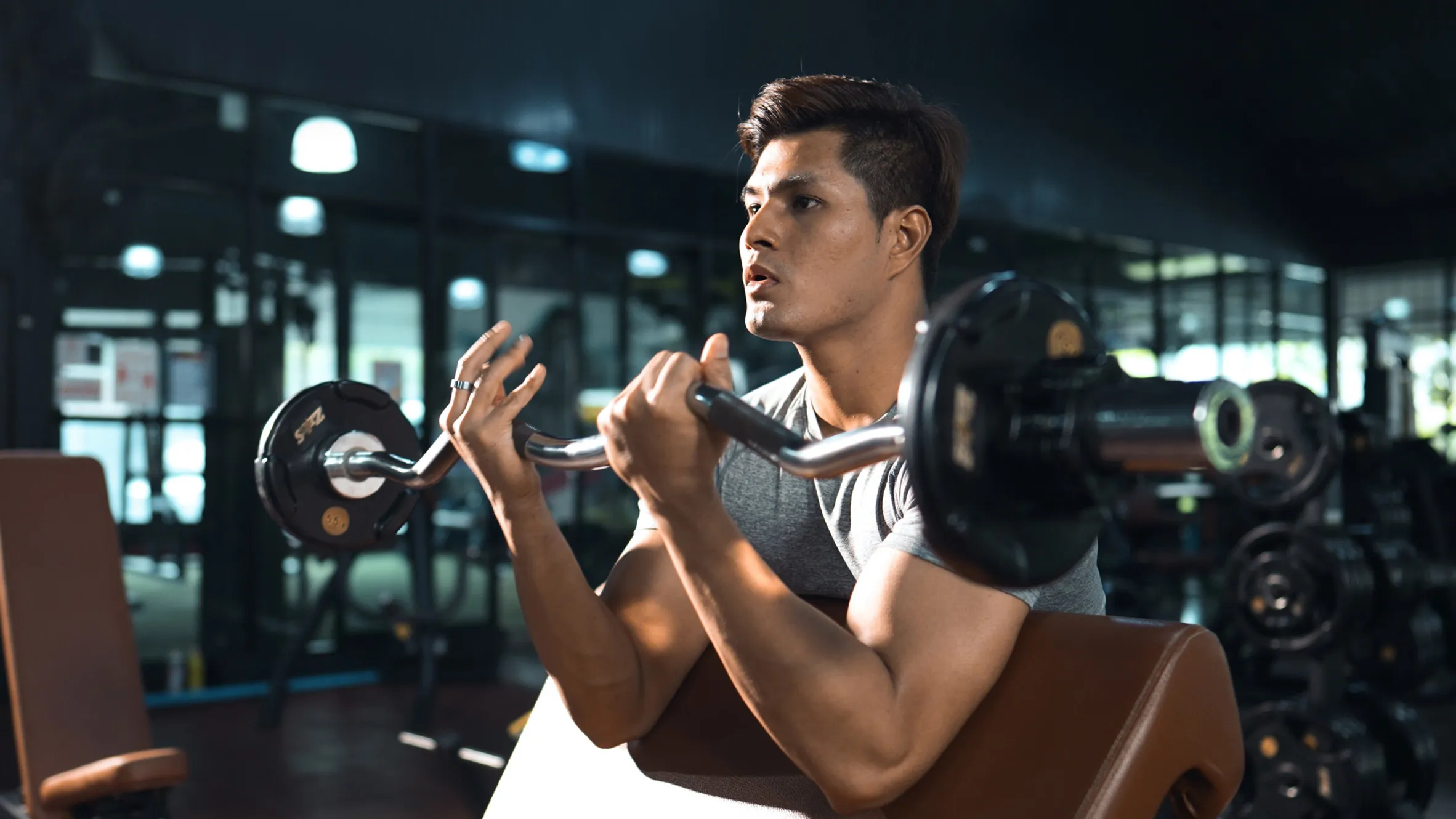 Man training with a barbell in a gym